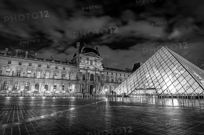 Louvre museum exterior at night in Paris