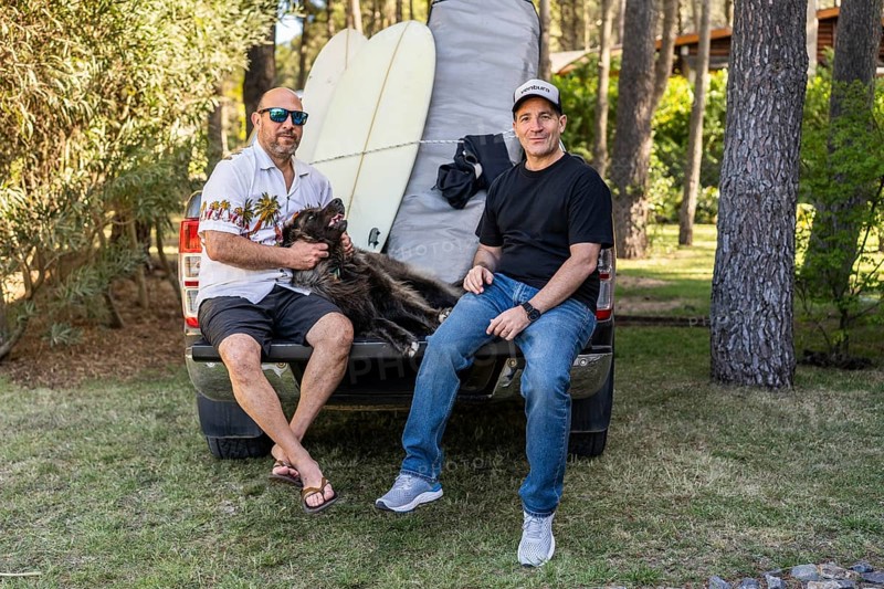 Friends and dog relaxing on a pickup truck