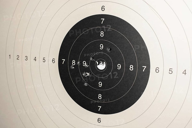 Hitmarks And Spot-On Hit On Round Paper Target With Bullet Holes From Shooting Training