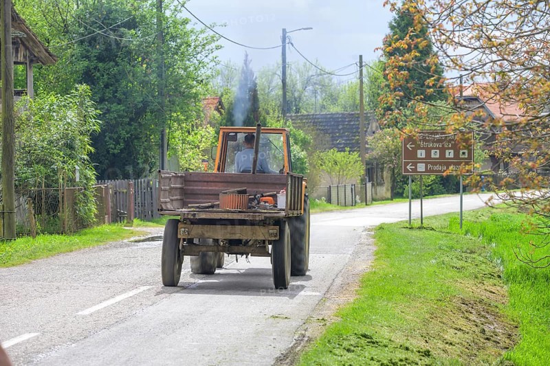 Tractor driving through the stork village, Cigoc, Sisak-Moslavina County, Croatia
