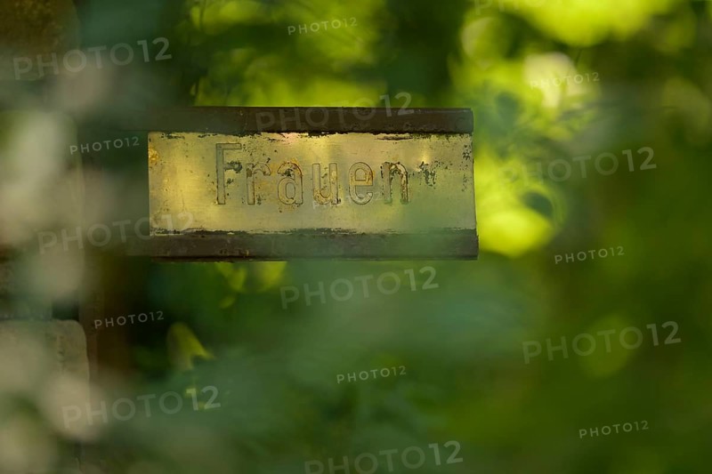 Old gilded sign with the inscription Women, weathered and surrounded by green vegetation, Ggenlicht, Rombergpark, Dortmund, North Rhine-Westphalia, Germany