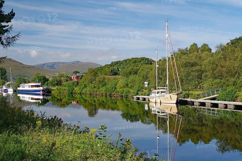 River landscape with boats and wooded hills in the background, Caledonian Canal, Fort William, Scotland, Great Britain
