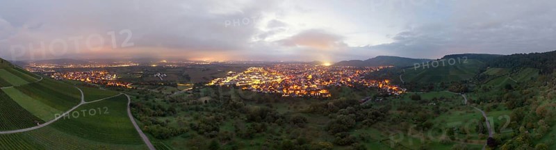 Dusk over an illuminated town, surrounded by vineyards and orchards, Korb and Kleinheppach in the Rems Valley, Baden-Württemberg, Germany