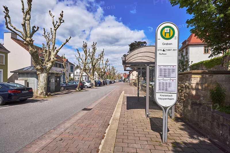 Bus stop Graben, bus shelter, public transport, public transport, street, multi-family houses, parking boxes, cars, street, blue sky, cumulus clouds, street Graben, Heppenheim, Odenwald, Bergstraße district, Hesse, Germany