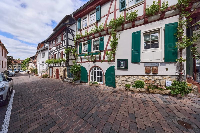 Old town, alley, historic half-timbered houses, facade with windows and shutters, cellar hatches, pavement of concrete paving stones, cloudy, diffuse light, slightly sunny, Kellereigasse, Heppenheim, Odenwald, Bergstrasse district, Hesse, Germany