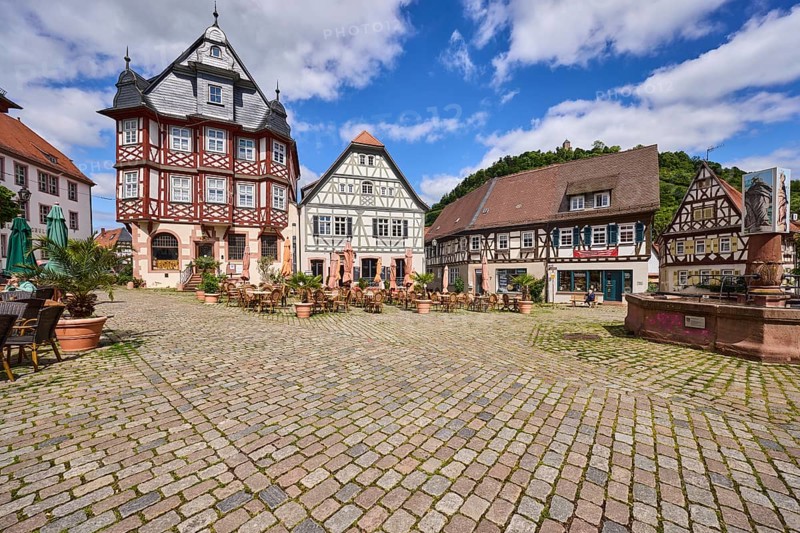 Old town, historic half-timbered houses, fountain, market fountain, cobblestone square, outdoor area of a restaurant, visitors as secondary motif, blue sky, cumulus clouds, market square, intersection between Großer Markt, Marktstraße, Amtsgasse, Mühlgasse and Schunkengasse, Heppenheim, Odenwald, Bergstraße district, Hesse, Germany