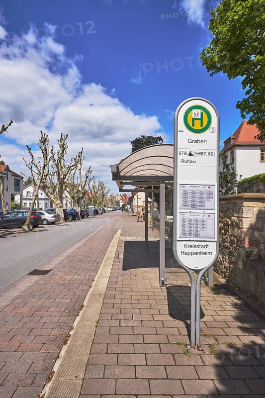 Bus stop Graben, bus shelter, public transport, public transport, street, multi-family houses, parking boxes, cars, street, blue sky, cumulus clouds, street Graben, Heppenheim, Odenwald, Bergstraße district, Hesse, Germany