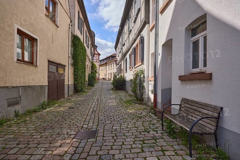 Old town, alley, cobblestone pavement, historic half-timbered houses, historic buildings, facades with windows, bench, shady, blue sky, cumulus clouds, Kleine Bach, Heppenheim, Odenwald, Bergstrasse district, Hesse, Germany