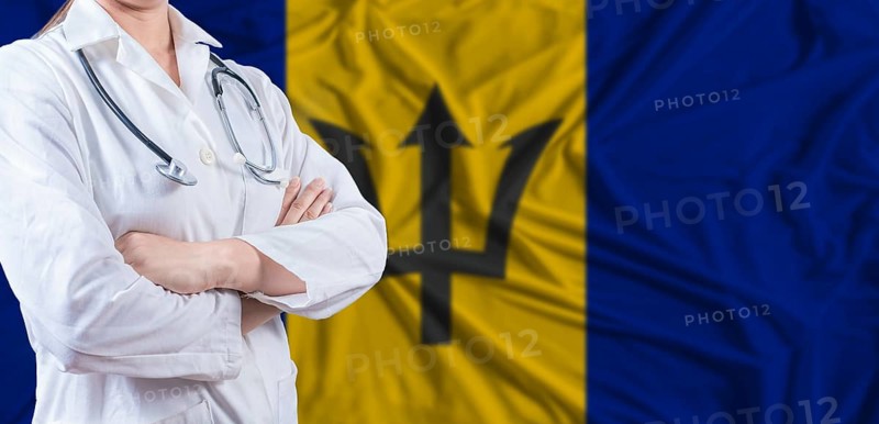Doctor with crossed arms on Barbados flag. Barbados health and care concept. Female doctor on Barbados flag