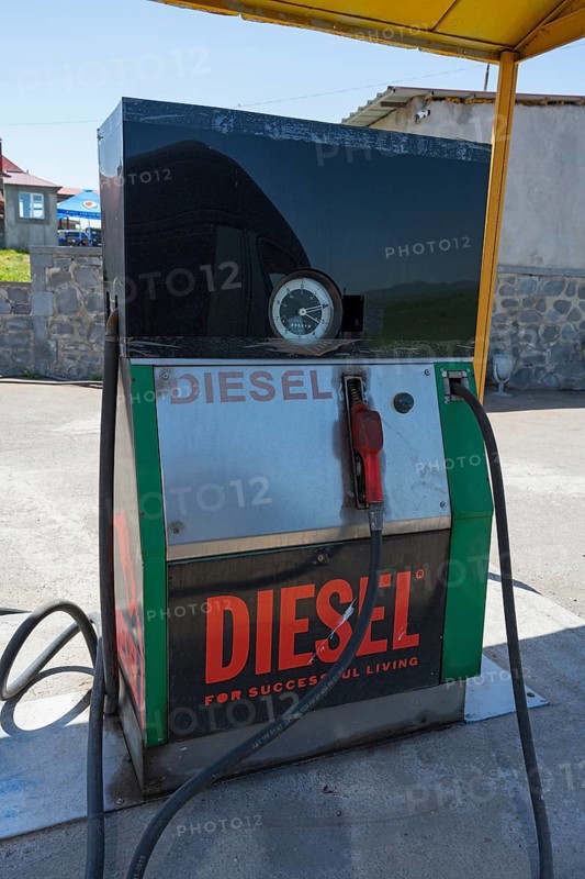 An old diesel pump at a petrol station with a large sign, diesel fuel pump, petrol station, petrol pump, Zyunik province, Armenia