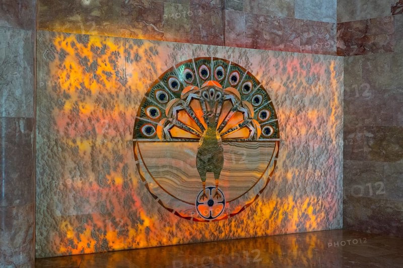 Detailed peacock pattern on a wall with orange lighting, showing symbolism and artistic decoration, Yazidi temple, Yazidi temple, the largest Yazidi temple in the world is called Quba Mere Diwane, Aknalich, Aknalich, Armavir district, Armenia