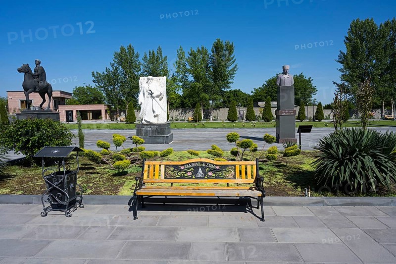 Park with colourful wooden benches, statues and surrounding trees, in the garden of the Yazidi Temple, Yazidi Temple, Aknalich, Aknalich, Armavir district, Armenia