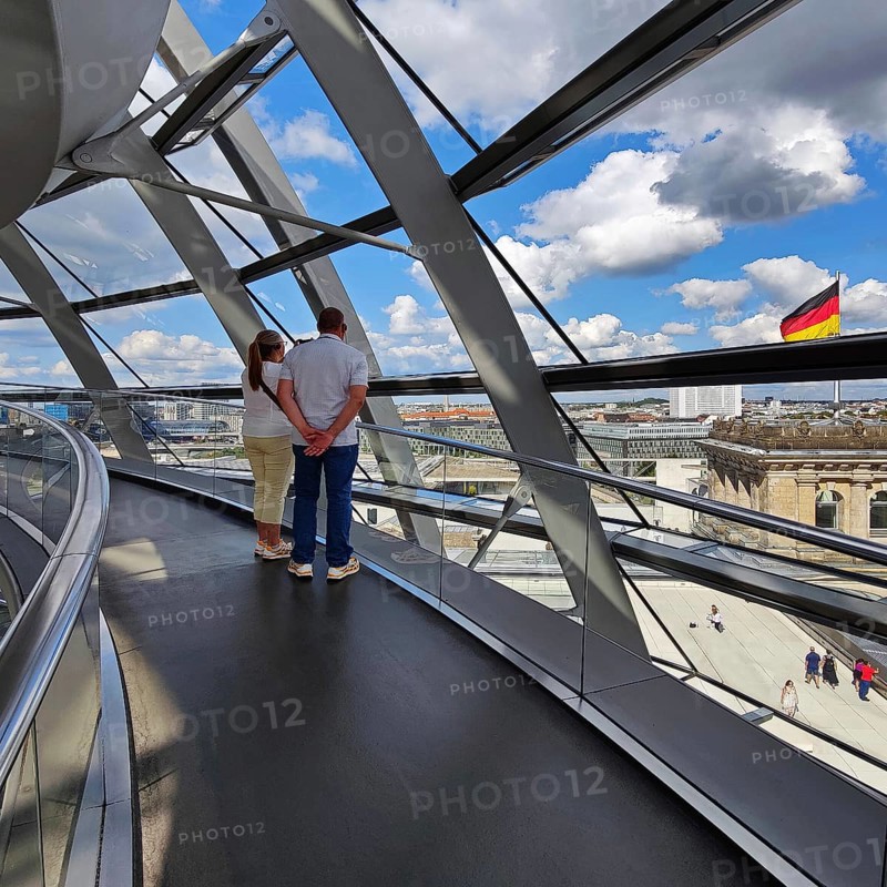 Interior view of the Reichstag dome with visitors and the German flag, Reichstag building, government district, Berlin, Germany