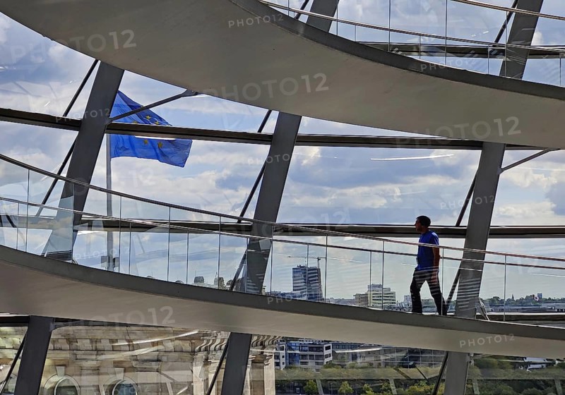 Interior view of the Reichstag dome with a view of a European flag and a person, Reichstag building, government district, Berlin, Germany