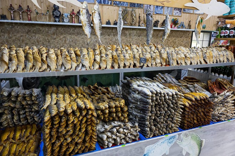 Different types of fish are displayed on a decorated shelf in a market, fish sale, Tsovagyugh, Lake Sevan, Gegharkunik province, Armenia
