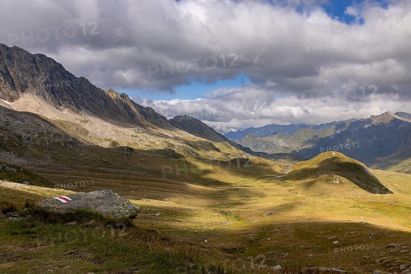 Alpe Carorescio with Piano Grande plateau and hiking trail marker, Quinto, Ticino, Switzerland