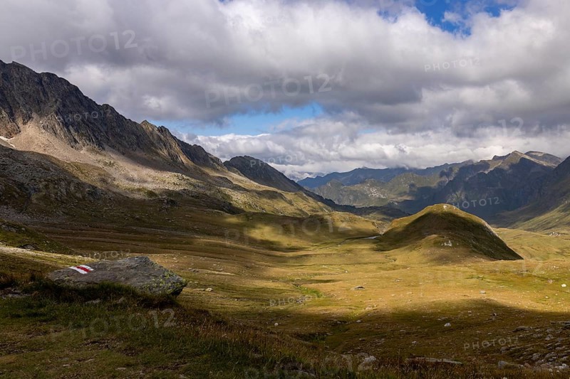 Alpe Carorescio with Piano Grande plateau and hiking trail marker, Quinto, Ticino, Switzerland