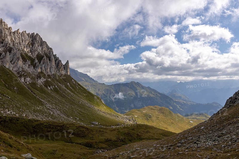 View from Passo del Sole towards Blenio Valley and Lukmanier, on the left steep rock faces at Campanítt, Pizz di Colómb, Olivone, Ticino, Switzerland