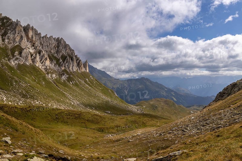 View from Passo del Sole towards Lukmanier and Blenio Valley, on the left steep rock faces at Campanítt, Pizz di Colómb, Olivone, Ticino, Switzerland