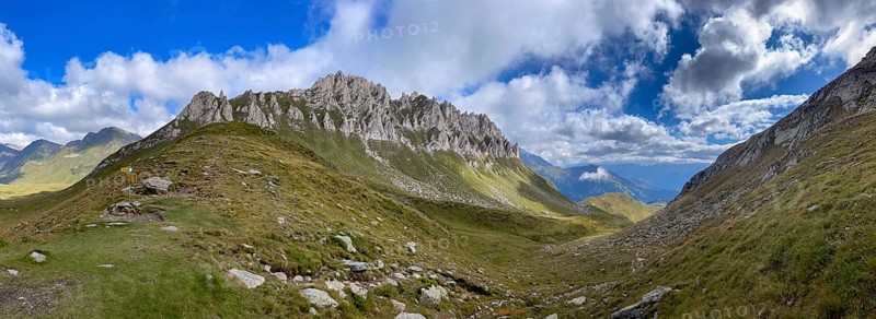 View from Passo del Sole towards Blenio Valley and Lukmanier, on the left steep rock faces at Campanítt, Pizz di Colómb, Olivone, Ticino, Switzerland