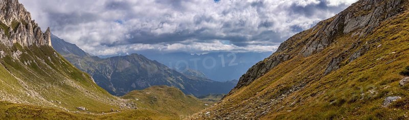 View from Passo del Sole towards Blenio Valley and Lukmanier, on the left steep rock faces at Campanítt, Pizz di Colómb, Olivone, Ticino, Switzerland