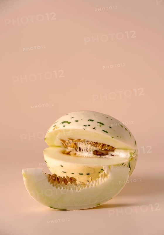 Hybrid honeydew melon on a beige background