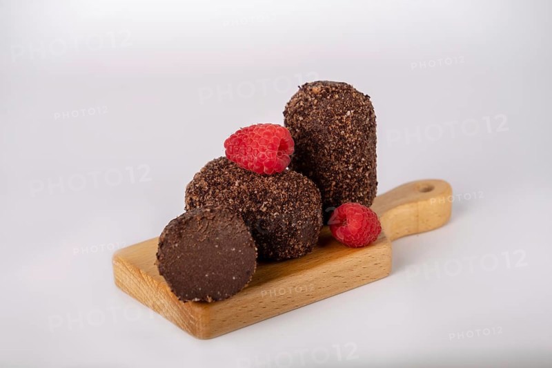 Cocoa and raspberry cake on a board, copy space
