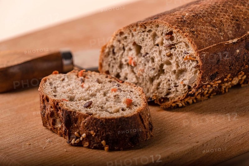 Slices of whole grain bread with carrots and seeds, close-up