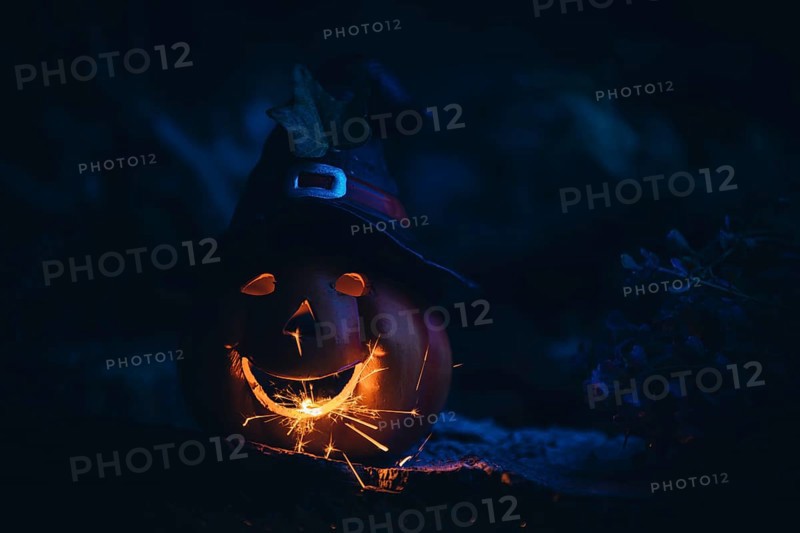Glowing pumpkin with sparks in the dark, Halloween