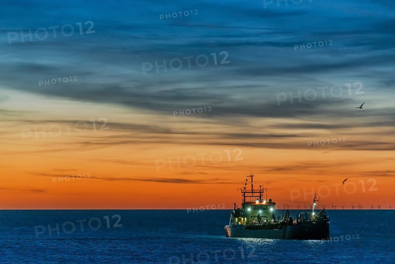 Coastal defence, hopper dredger, suction dredger in the evening light off the coast of the North Sea island of Sylt