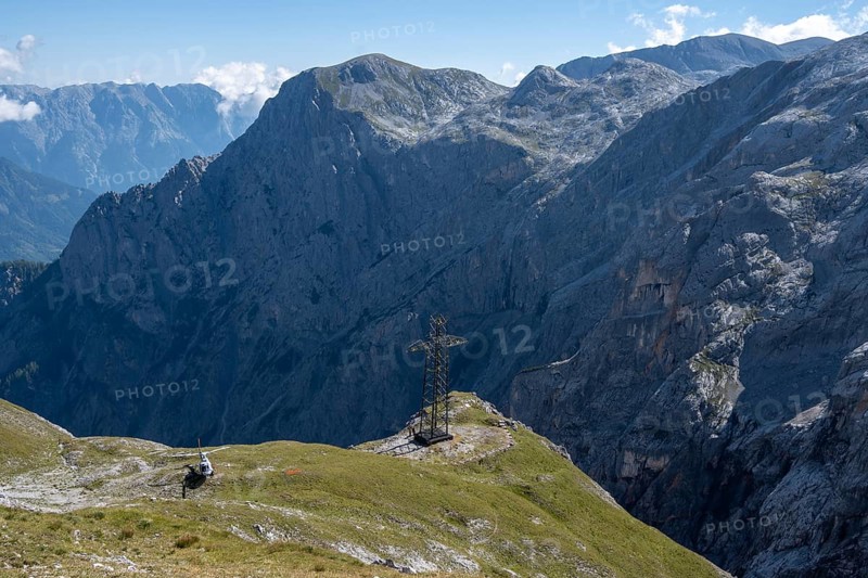 Dismantling of the old 220 kV power line at the Torscharte at the transition towards the Hagengebirge. It will be replaced by the new 380 kV Salzburg line. The electricity pylons and cables are removed in individual parts by helicopter. Salzburger Land, Austria