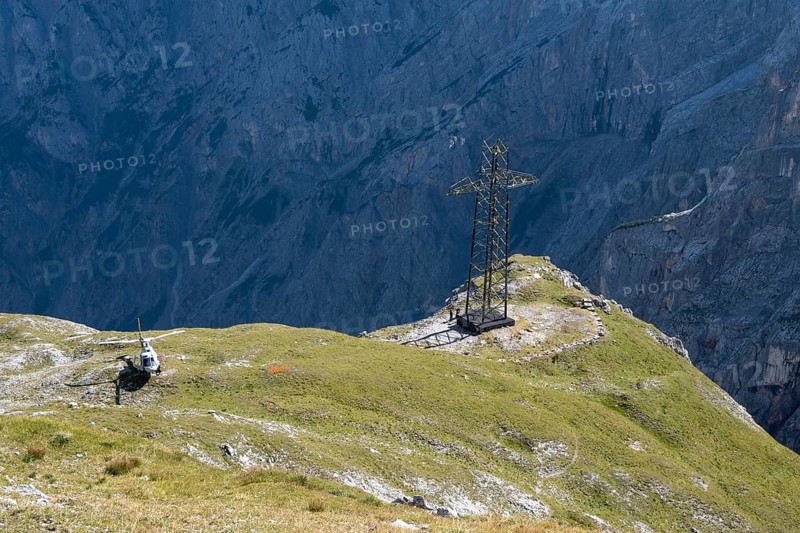 Dismantling of the old 220 kV power line at the Torscharte at the transition towards the Hagengebirge. It will be replaced by the new 380 kV Salzburg line. The electricity pylons and cables are removed in individual parts by helicopter. Salzburger Land, Austria