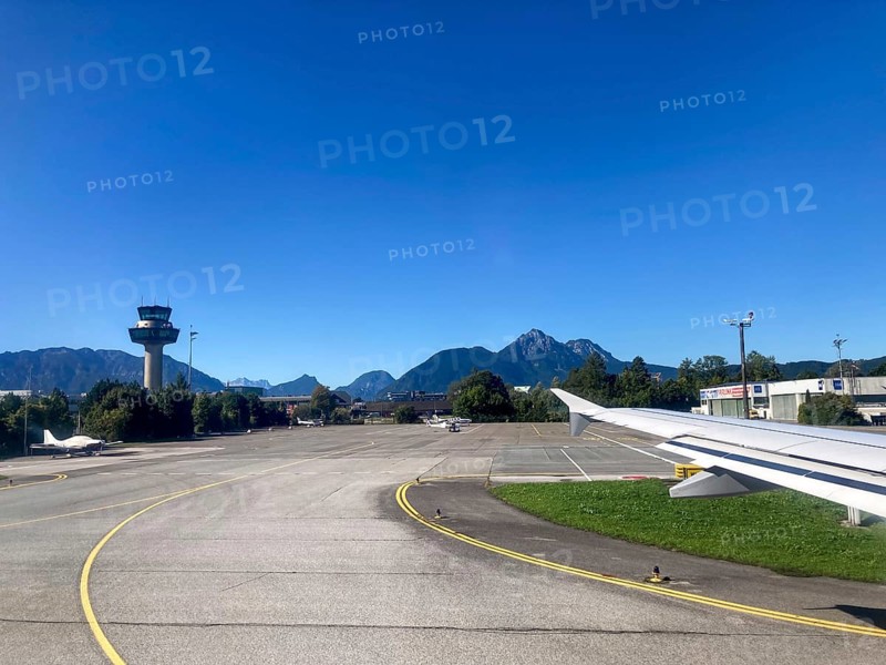 View of the tower and the Hochstaufen, Salzburger Land, Austria, from the aircraft on take-off from Salzburg Airport