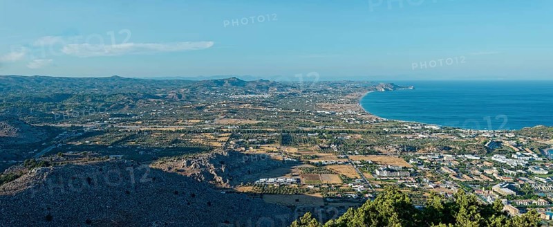 Expansive coastal landscape of Kolymbia and Faliraki, with mountain ranges and coastline under a clear blue sky, Church of the Virgin Mary Tsambika (Kyra Psili), Archangelos, Rhodes Island, Greece