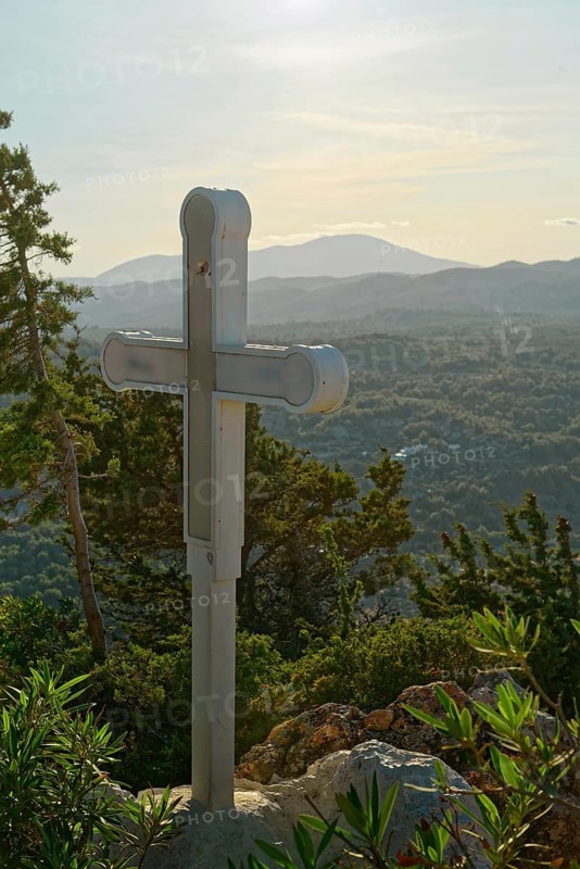 A wooden cross on a hill with a view of mountains and wooded landscape, Church of the Virgin Mary Tsambika (Kyra Psili), Archangelos, Rhodes Island, Greece
