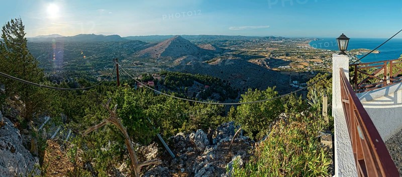 Panoramic view over the Mediterranean landscape of Kolymbia and Faliraki with mountains, coast and lush greenery in sunlight, Church of the Virgin Mary Tsambika (Kyra Psili), Archangelos, Rhodes Island, Greece