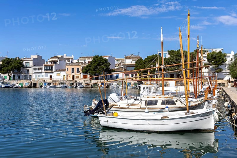 Portocolom fishing village on Majorca with boats and colourful houses Holiday by the sea in Portocolom, Spain