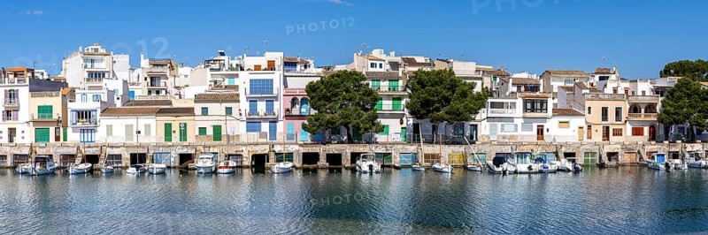 Colourful houses in Portocolom Fishing village on Majorca with boats Holiday by the sea Panorama trip in Portocolom, Spain