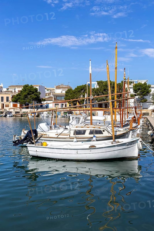 Portocolom fishing village on Majorca with boats and colourful houses Holiday by the sea in Portocolom, Spain