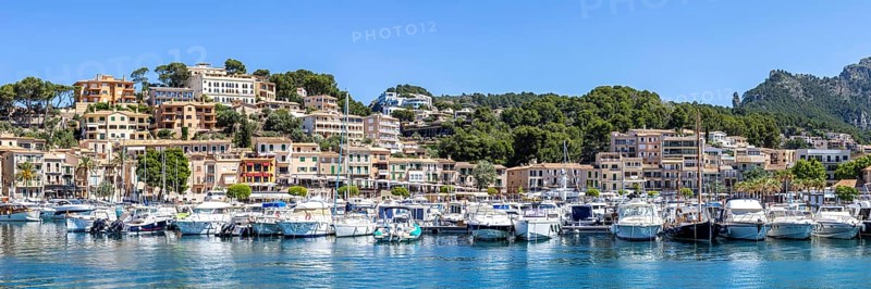 Port de Soller town on Majorca holiday by the sea yacht harbour with boats panoramic trip in Port de Sóller, Spain