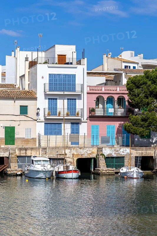 Colourful houses in Portocolom Fishing village on Majorca with boats Seaside holiday in Portocolom, Spain