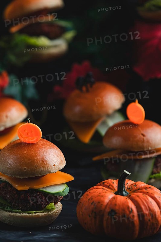 Small burgers with pumpkin in an autumnal, spooky atmosphere