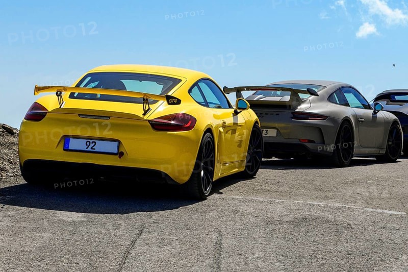Sports car for public traffic Road-approved road version of racing car with rear wing spoiler with road approval, left front Porsche Cayman GT4, behind it Porsche 911 GT3, international
