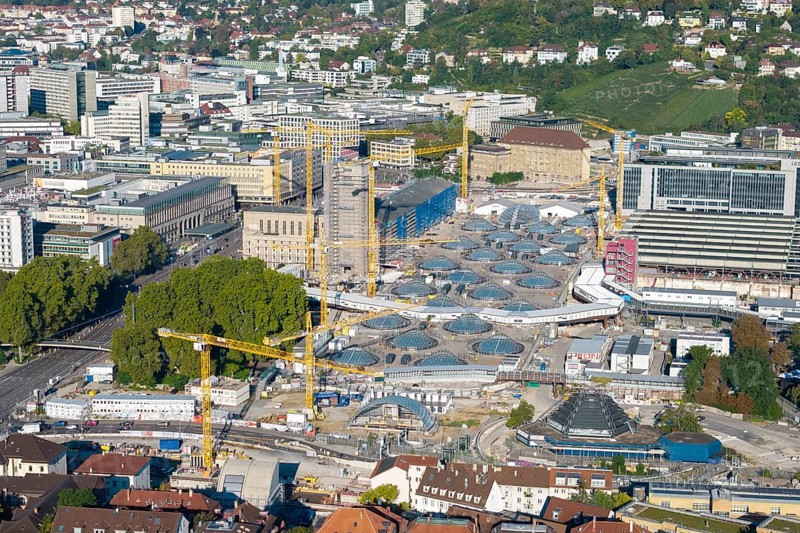 Urban construction project with glass structures and cranes, embedded in a green urban backdrop, large construction site, Stuttgart railway station, Stuttgart 21, Baden-Württemberg, Germany