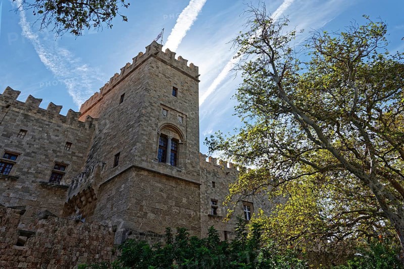 Medieval castle with stone towers under a clear sky and surrounded by trees, d'Amboise Gate, Medieval Town of Rhodes, Rhodes Island, Greece