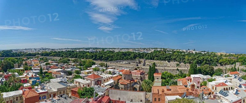 Historic old town with colourful houses and green trees under a clear blue sky, Roloi Clock Tower, Medieval Town of Rhodes, Rhodes Island, Greece