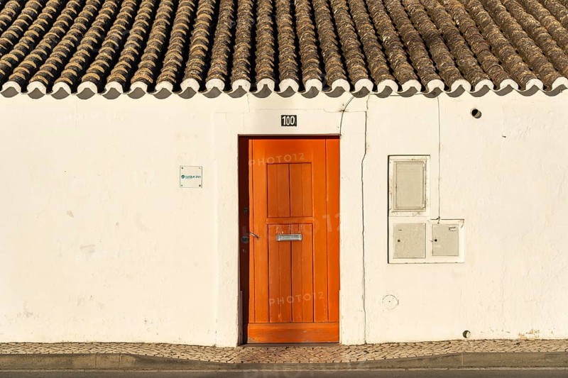 House with orange door, old building in the historic centre of Tavira, Algarve, Portugal