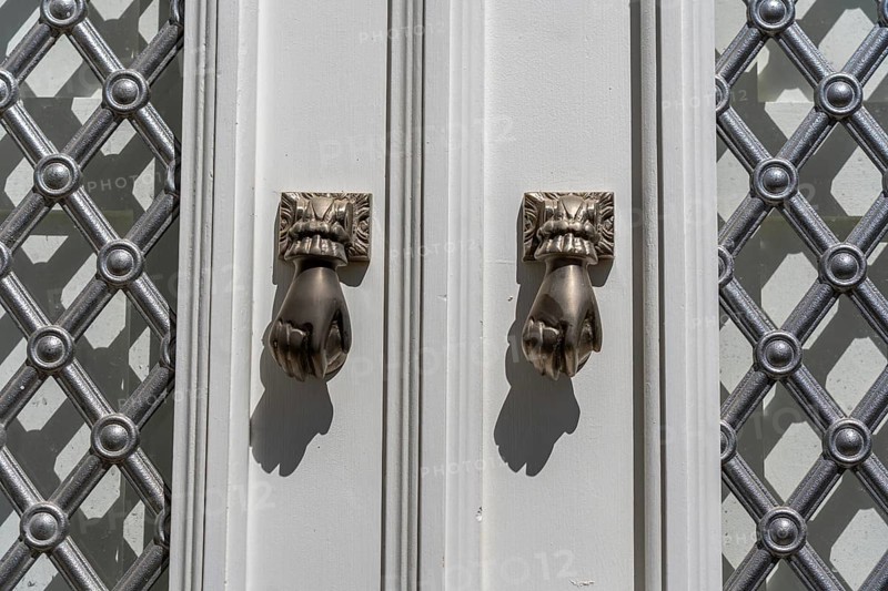 The old town centre of Tavira, typical door knockers found on many wooden doors in the town, Algarve, Portugal