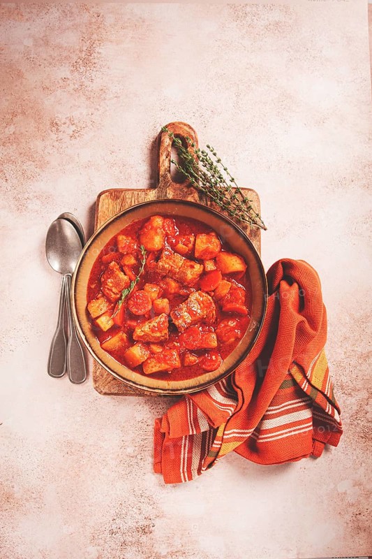 Meat goulash with potatoes and carrots, sweet peppers, in a saucepan, top view, traditional Hungarian soup, homemade, no people