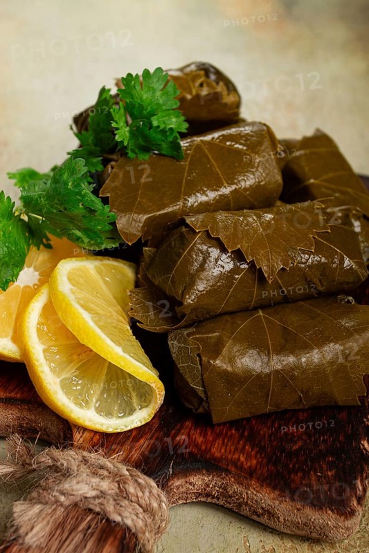Dolma, minced meat with rice, in grape leaves, minced meat rolls, on a chopping board, top view, no people